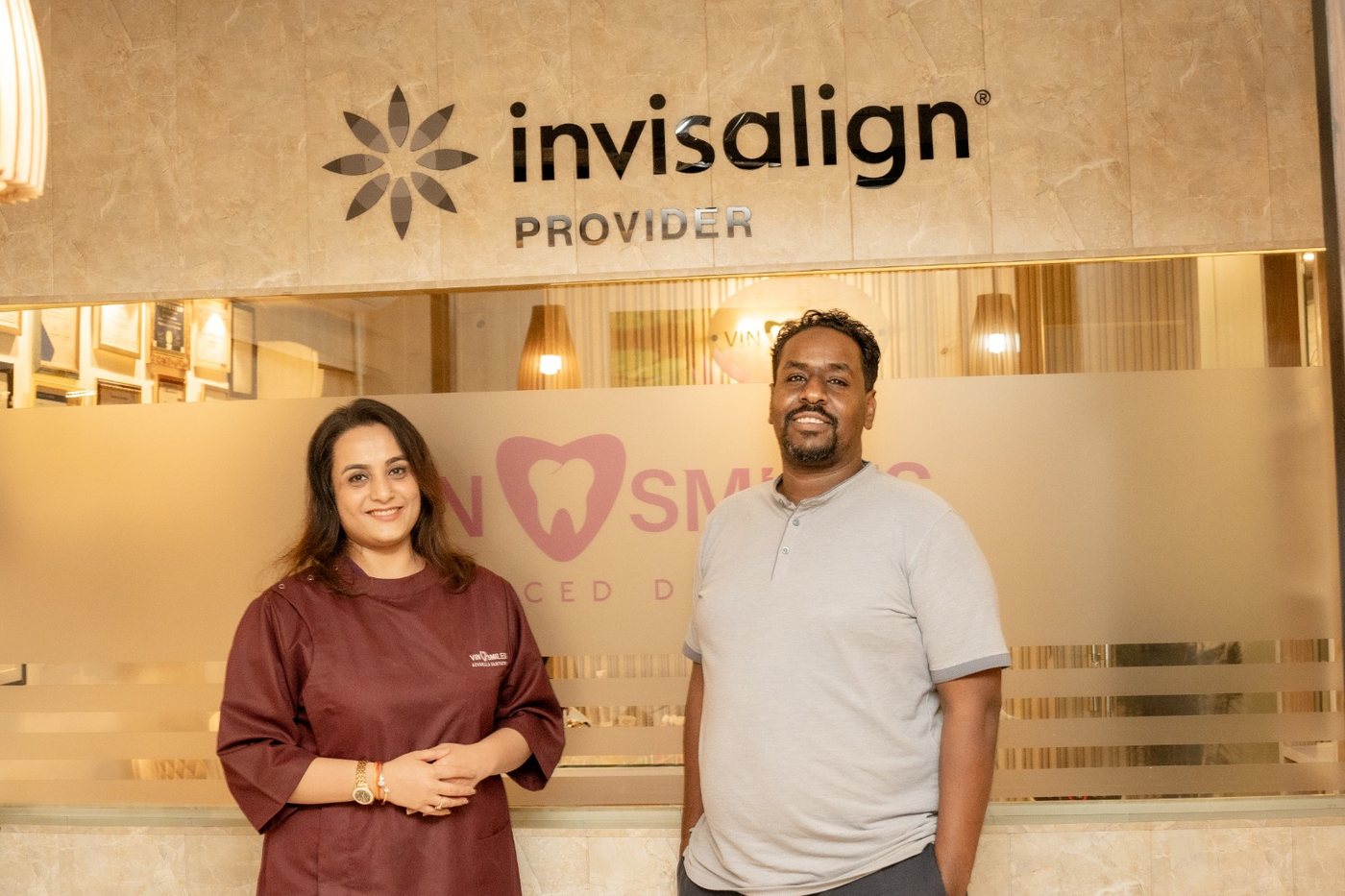 A patient at the Invisalign Provider wall at VIN SMILES