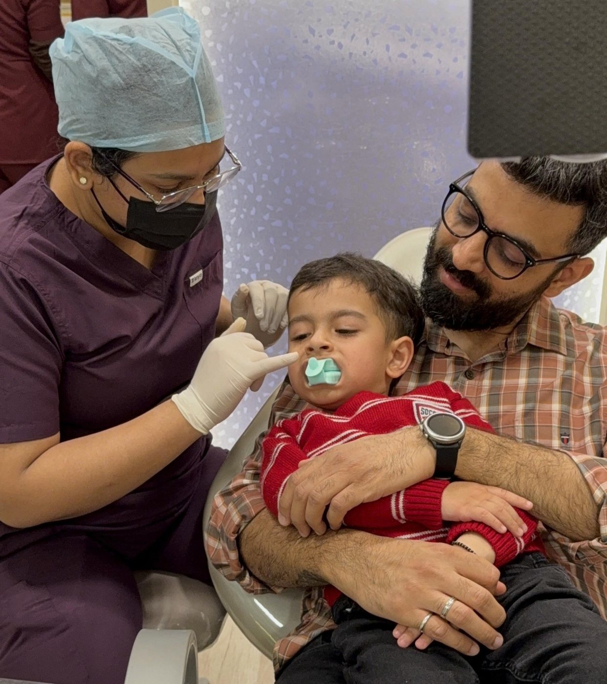 A young child treated on a parent's lap